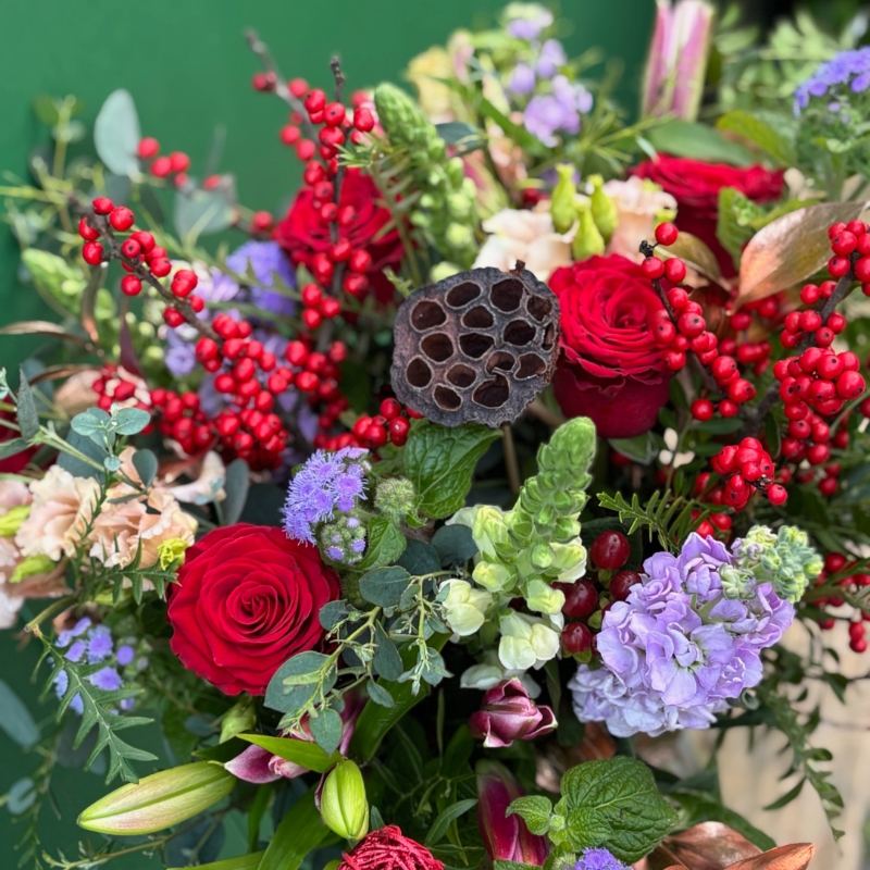 Christmas bouquet with berries and roses available for delivery before Christmas 