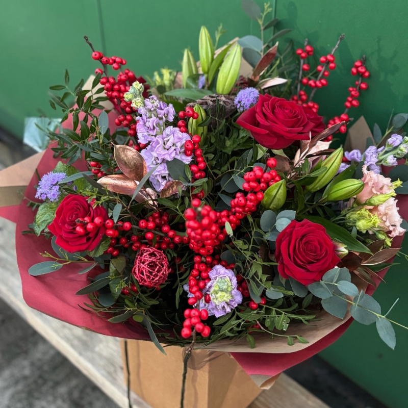 Christmas bouquet with berries and roses available for delivery before Christmas 
