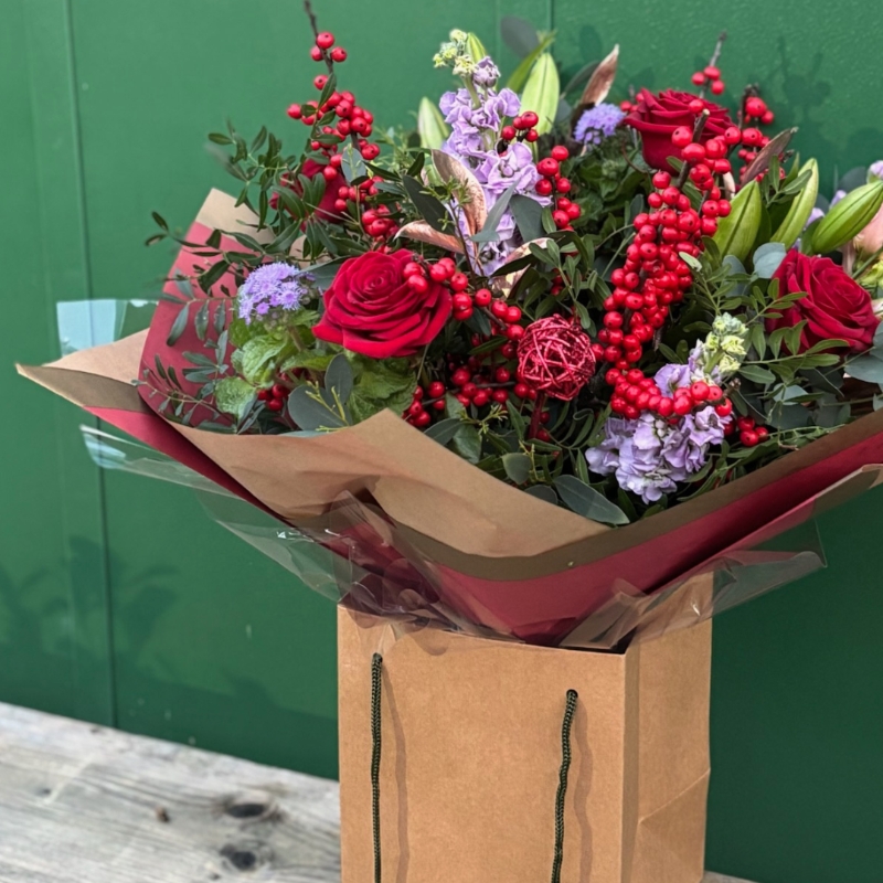 Christmas bouquet with berries and roses available for delivery before Christmas 