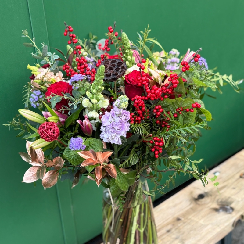 Christmas bouquet with berries and roses available for delivery before Christmas 