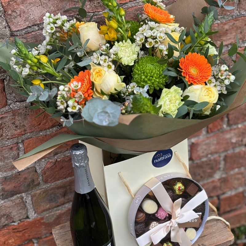 Mother's Day Bouquet with buttercup yellows, creams and greens with bright pops of orange