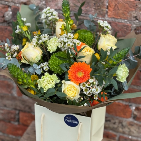Mother's Day Bouquet with buttercup yellows, creams and greens with bright pops of orange