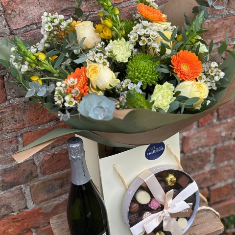 Mother's Day Bouquet with buttercup yellows, creams and greens with bright pops of orange