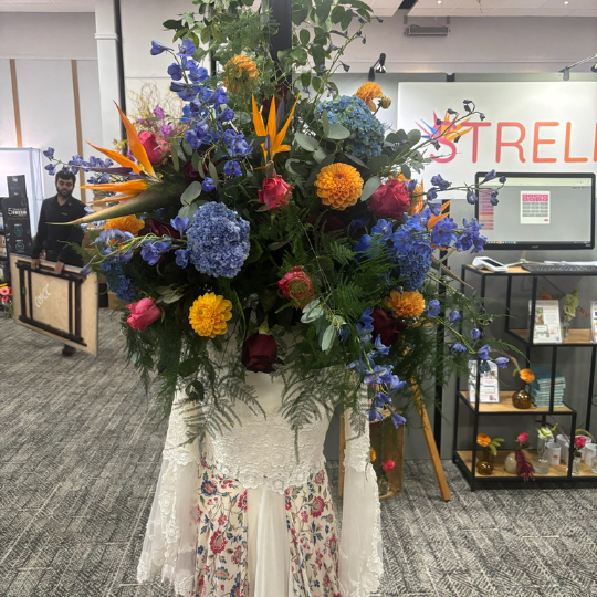 Large colourful flower installation of bride with head of flowers
